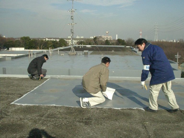 屋上の防水現況を確認する人々